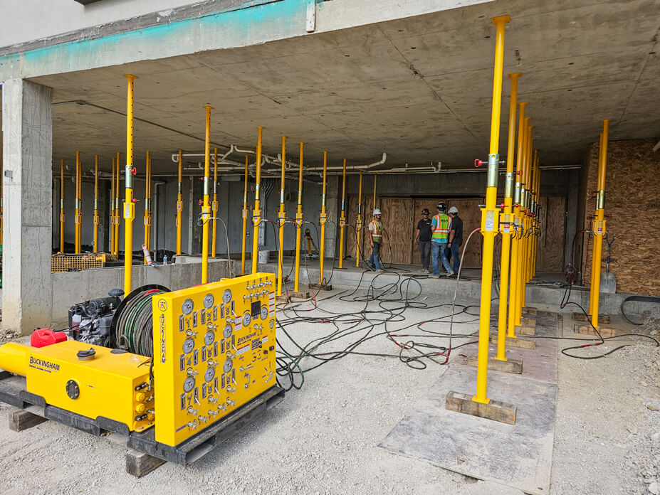 Buckingham unified jacking machine with jacking-shoring posts supporting cement floor system