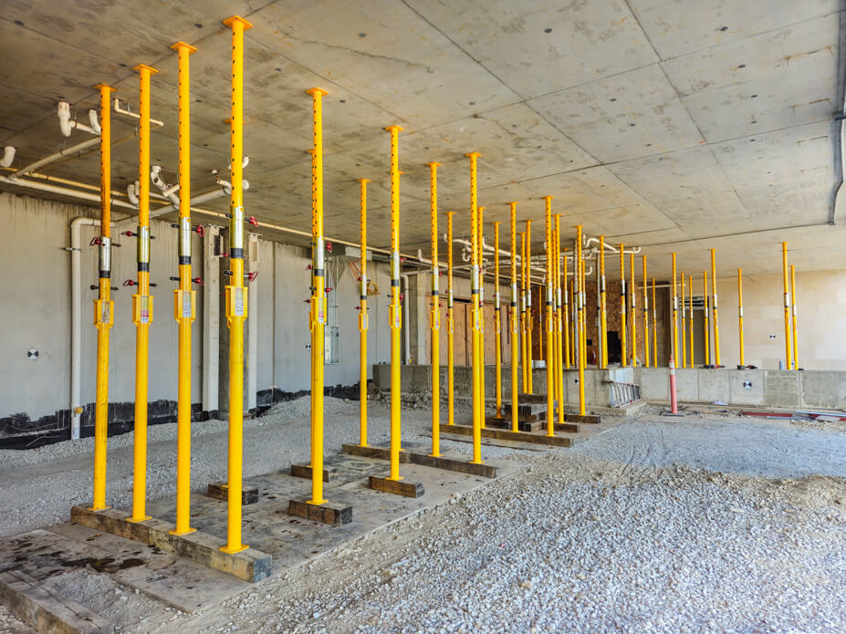 Buckingham jacking-shoring posts support a cement ceiling