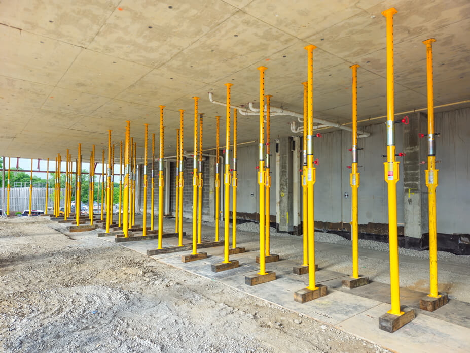 Wolfe uses rows of yellow Buckingham jacking-shoring posts to shore a building