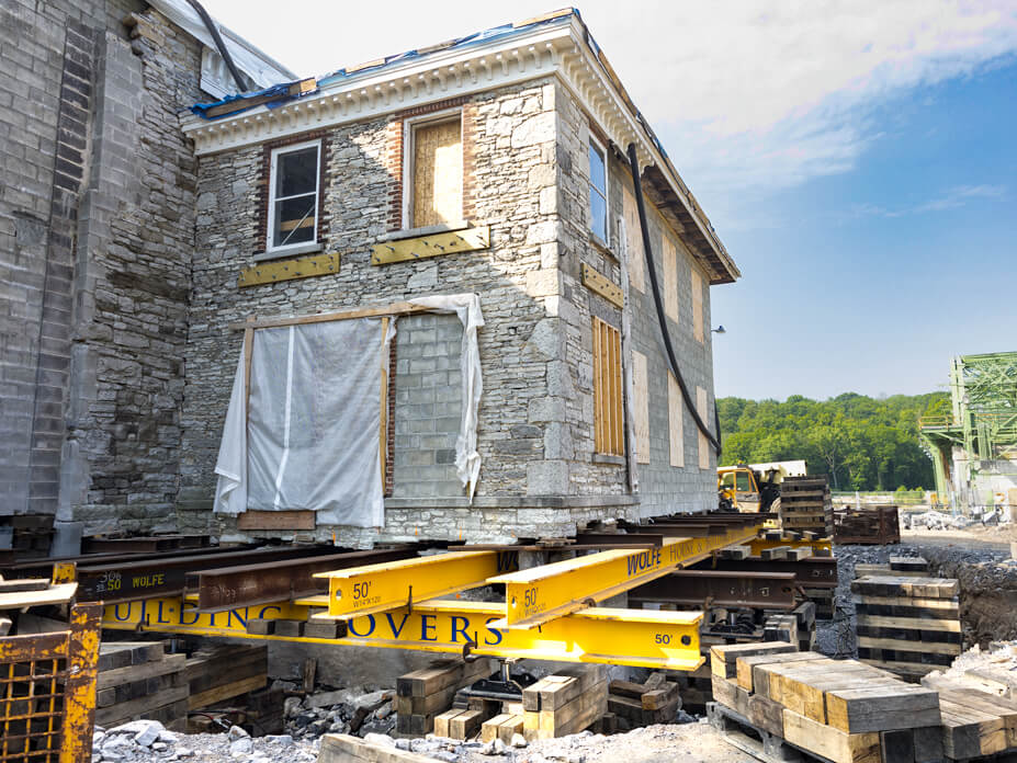 Corner view of Guy Park Manor with steel beams and cribbing