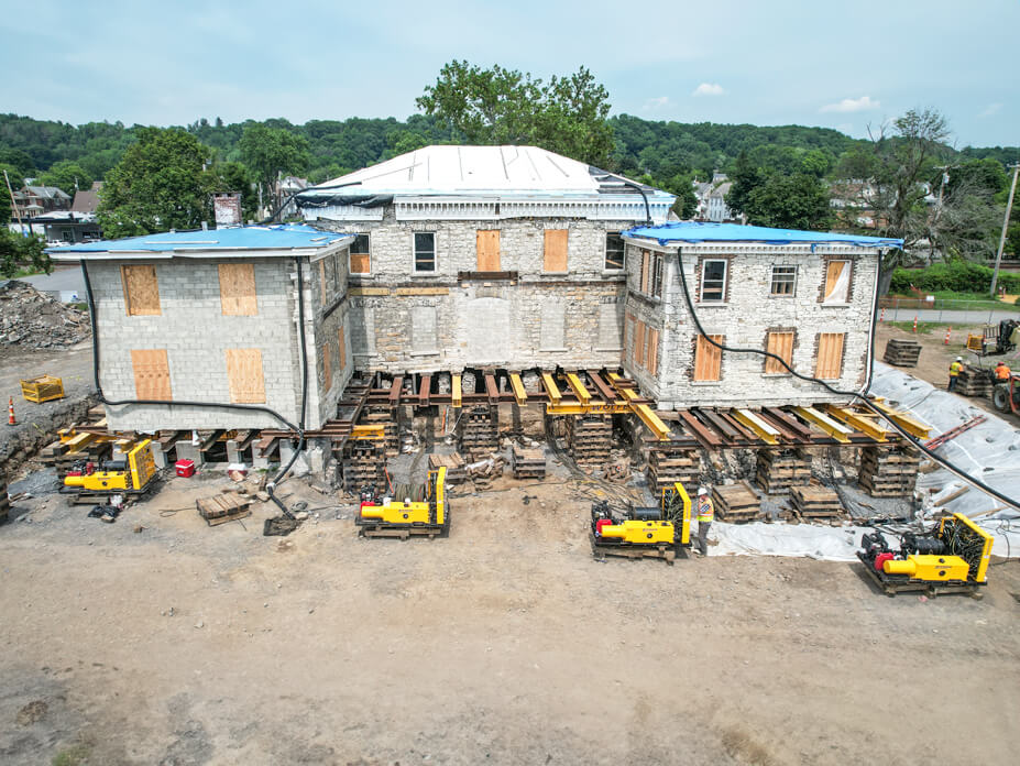 Aerial front view of Guy Park Manor with steel, crib, and unified jacking machines