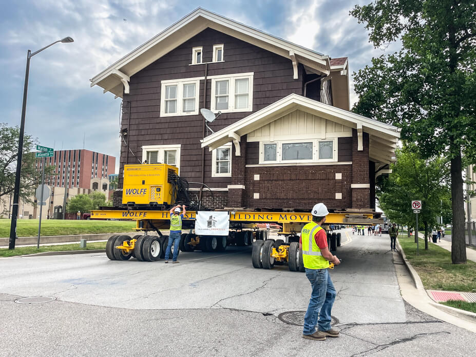 Wolfe foreman drives house on dollies down the street