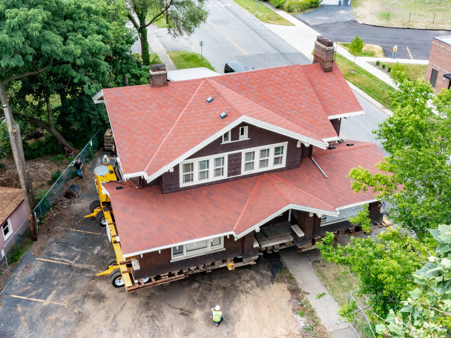 Wolfe drives house over sidewalk into new destination