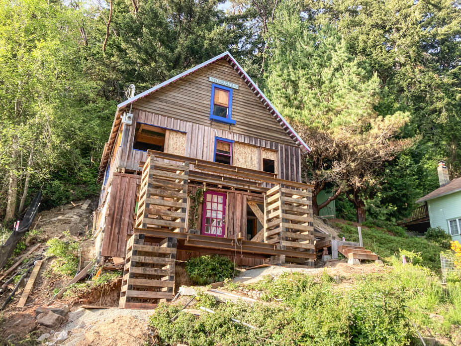 Crib stacked in front of frame cottage