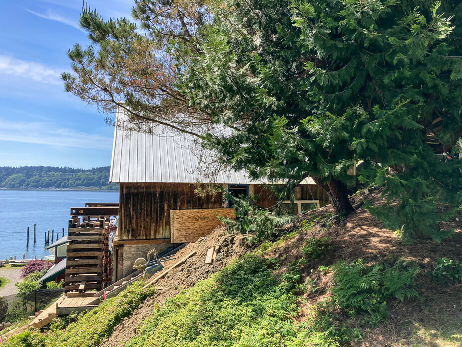 Side view of cottage with steel and crib and lake in background