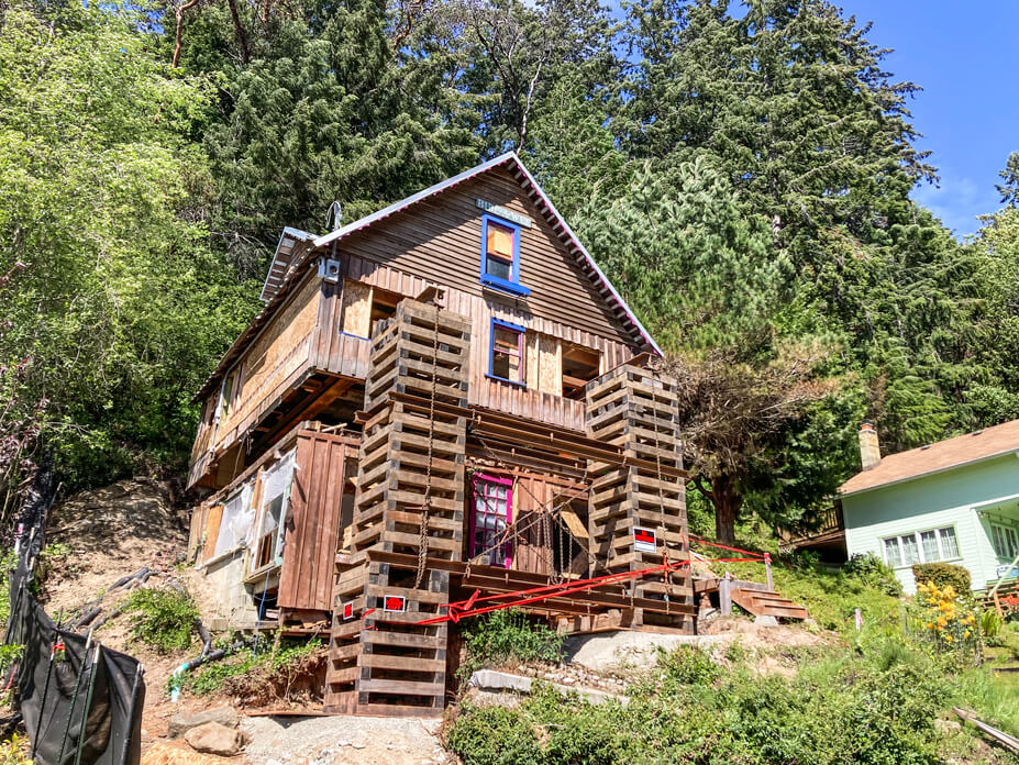 Front corner view of house supported with steel and crib