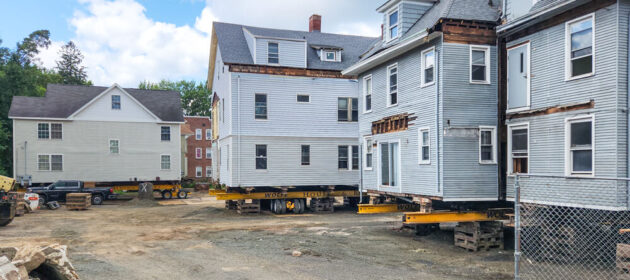 Several houses sit on dollies and cribbing in Hartford, CT, as Wolfe prepares to relocate them.