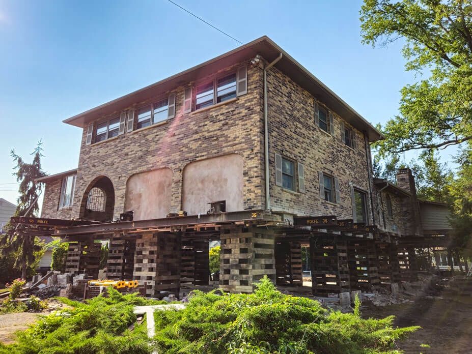 Wolfe lifts brick veneer NJ house on steel and cribbing for flood mitigation