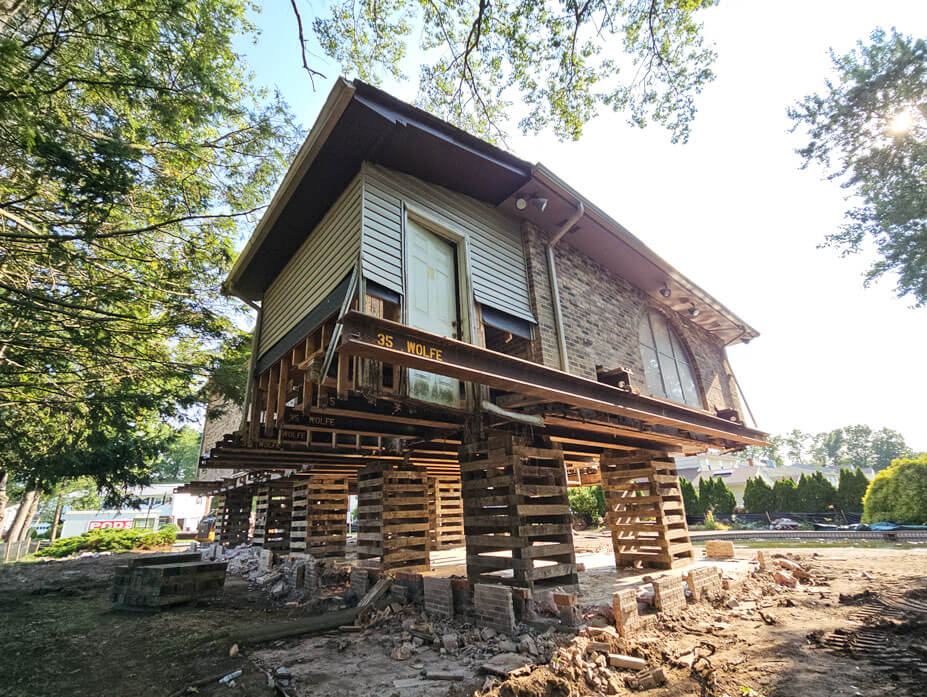 Corner view of NJ house in flood zone lifted on cribbing and steel 