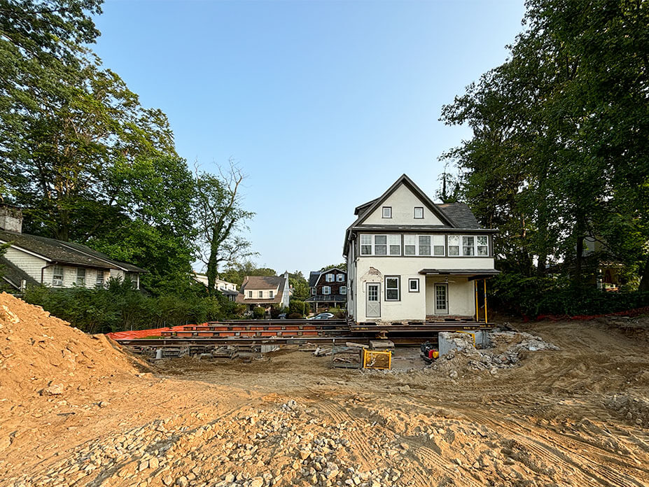 terracotta house sits on roll beams ready to slide to new location