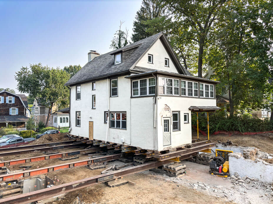 White 2½-story house sits on steel beams 