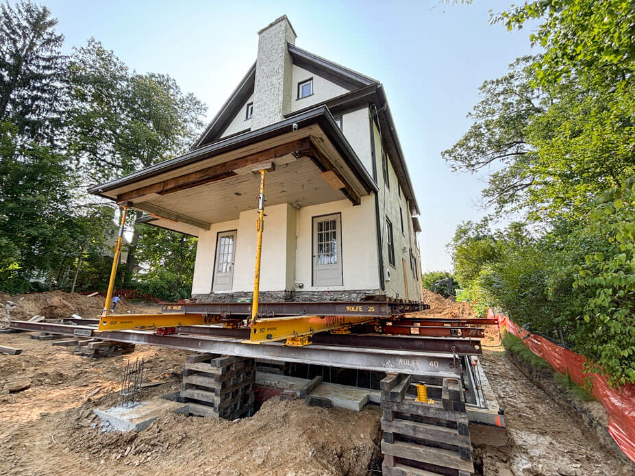 Buckingham jacking-shoring posts support its roof while Wolfe slides a 2-story house to its new location